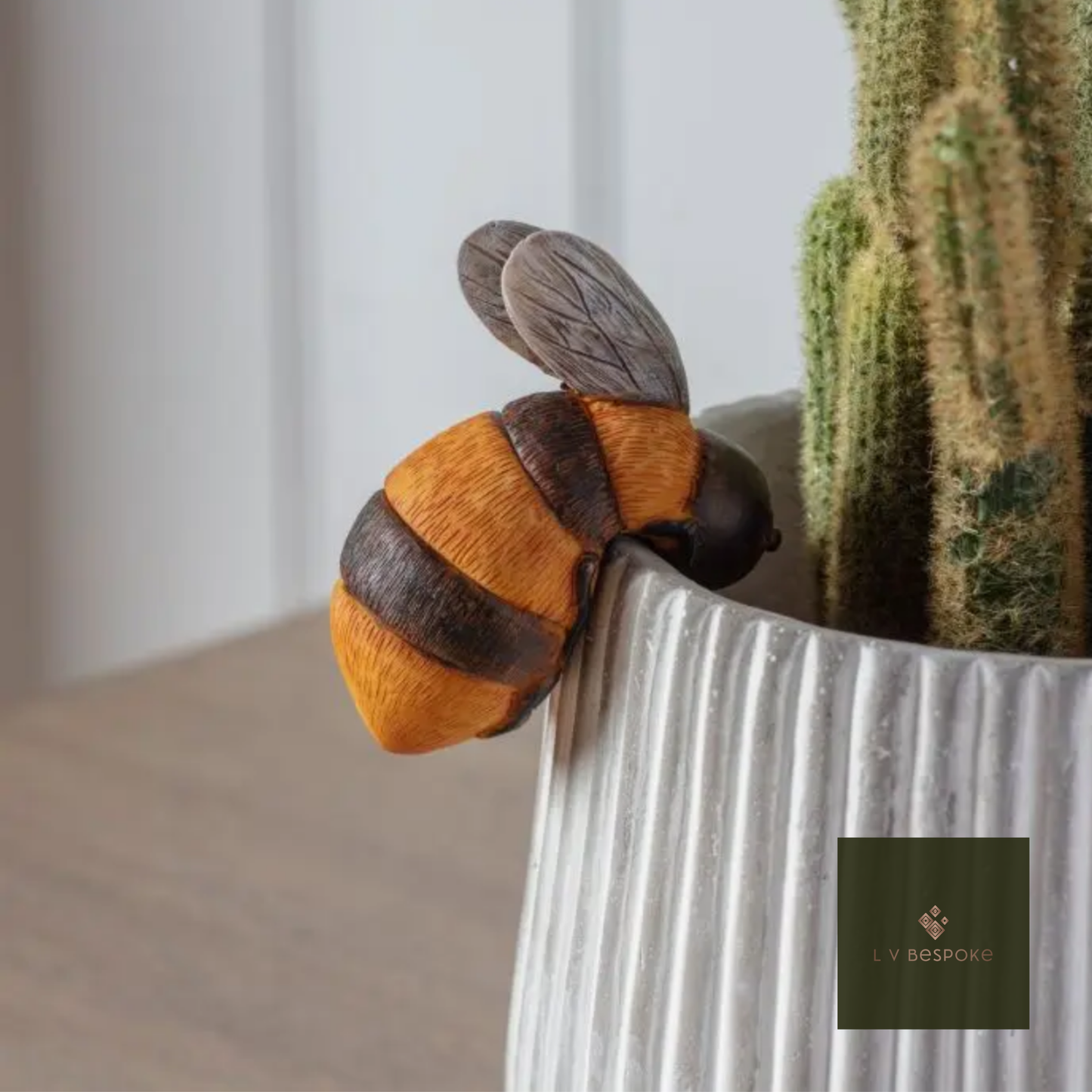 Bee decoration on a textured white surface with a blurred background