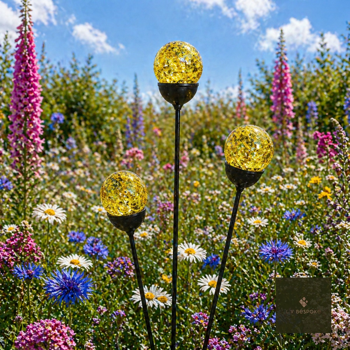 Yellow cracked glass orb cluster of three in a wildflower meadow