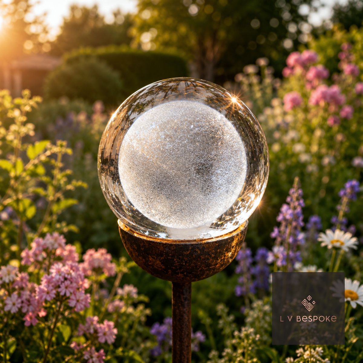 Raw steel garden stake with a clear glass orb holding a 3D Moon design, planted in a border