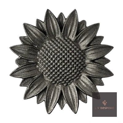 Raw steel Sunflower 2 flower head on a garden stake, planted in a border