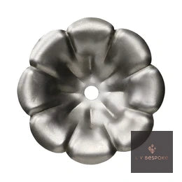 Raw steel Petal flower head on a garden stake, planted in a border