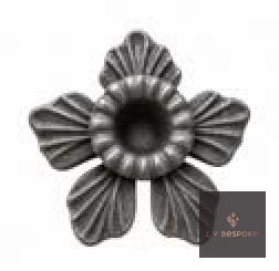 Raw steel Daffodil flower head on a garden stake, planted in a border