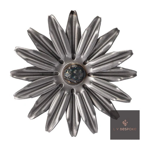 Raw steel Flower 2 flower head on a garden stake, planted in a border