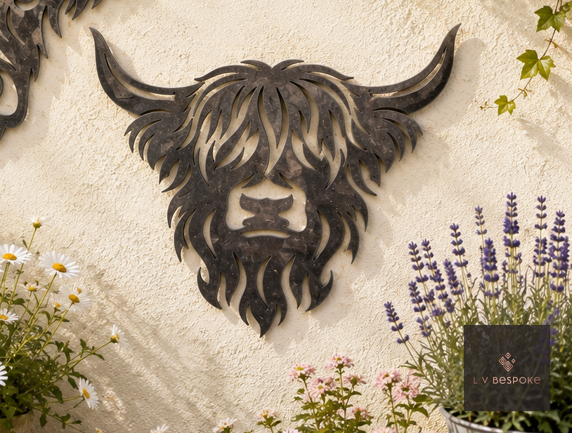 Raw steel Highland Cow Face wall art on a garden wall