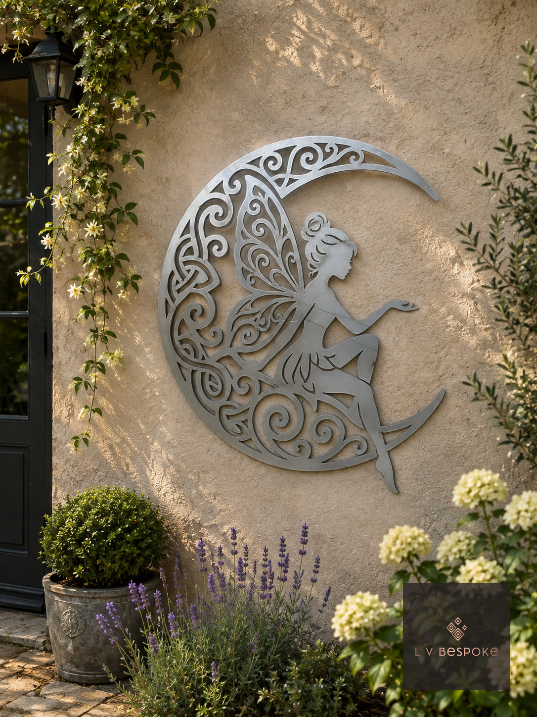 Raw steel Fairy on Moon wall art hung on a garden wall