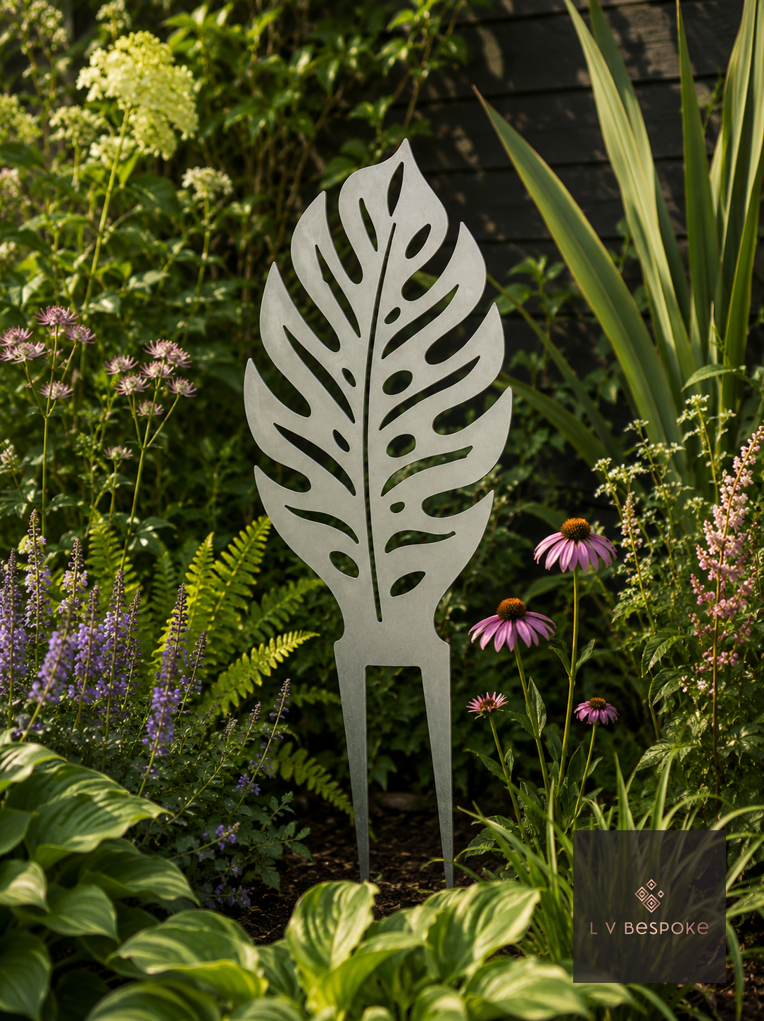 Raw steel Monstera Leaf Garden Stake in a garden border or on a wall