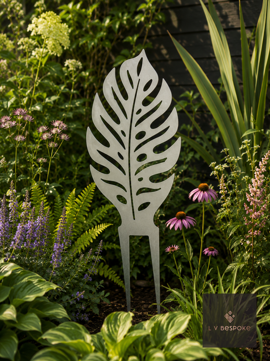 Raw steel Monstera Leaf Garden Stake in a garden border or on a wall