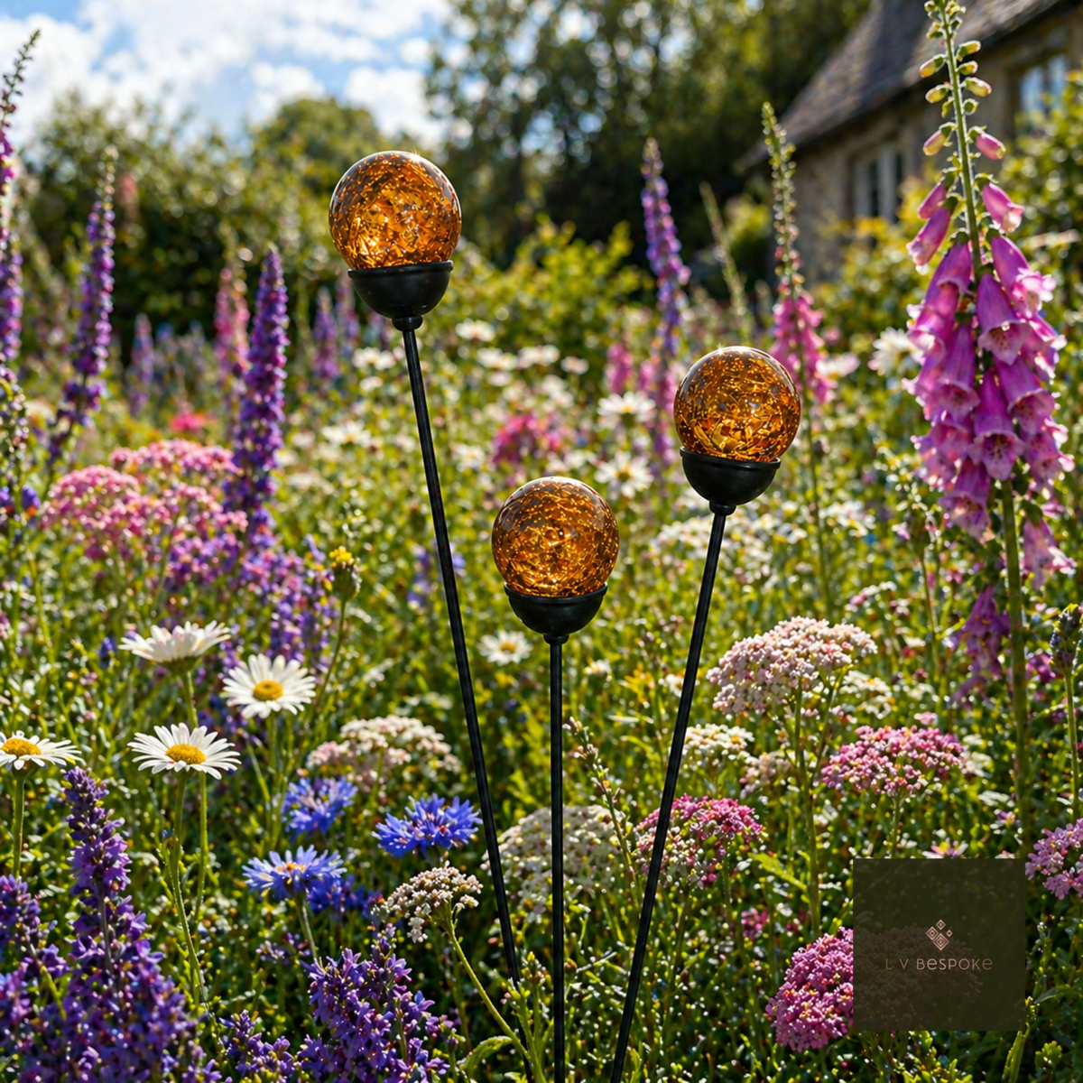 Amber cracked glass orb cluster of three in a wildflower meadow