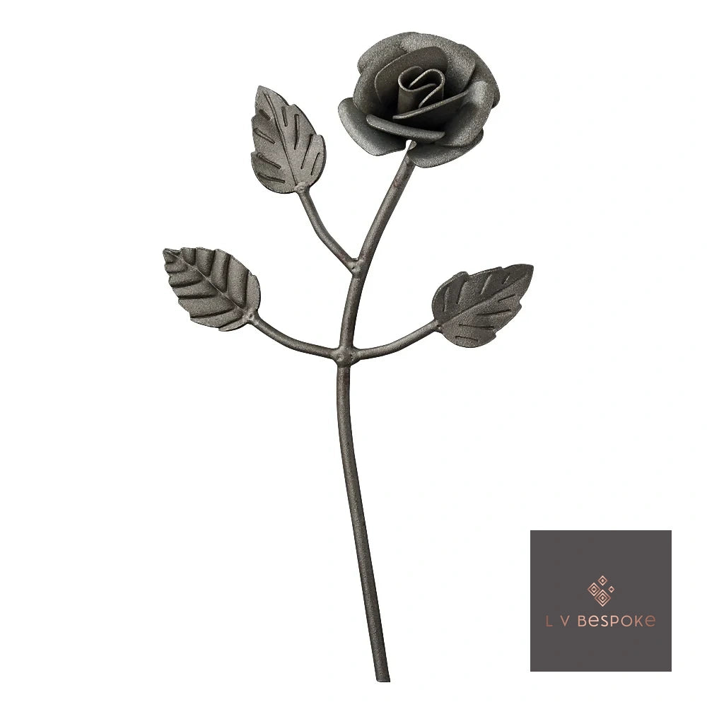 Raw steel Rosebud flower head on a garden stake, planted in a border