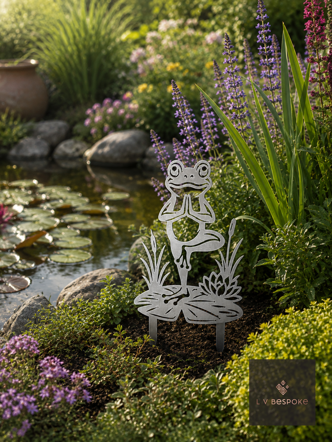 Raw steel Frog Garden Stake standing in a border
